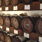 Wooden barrels aging balsamic vinegar in a traditional cellar.
