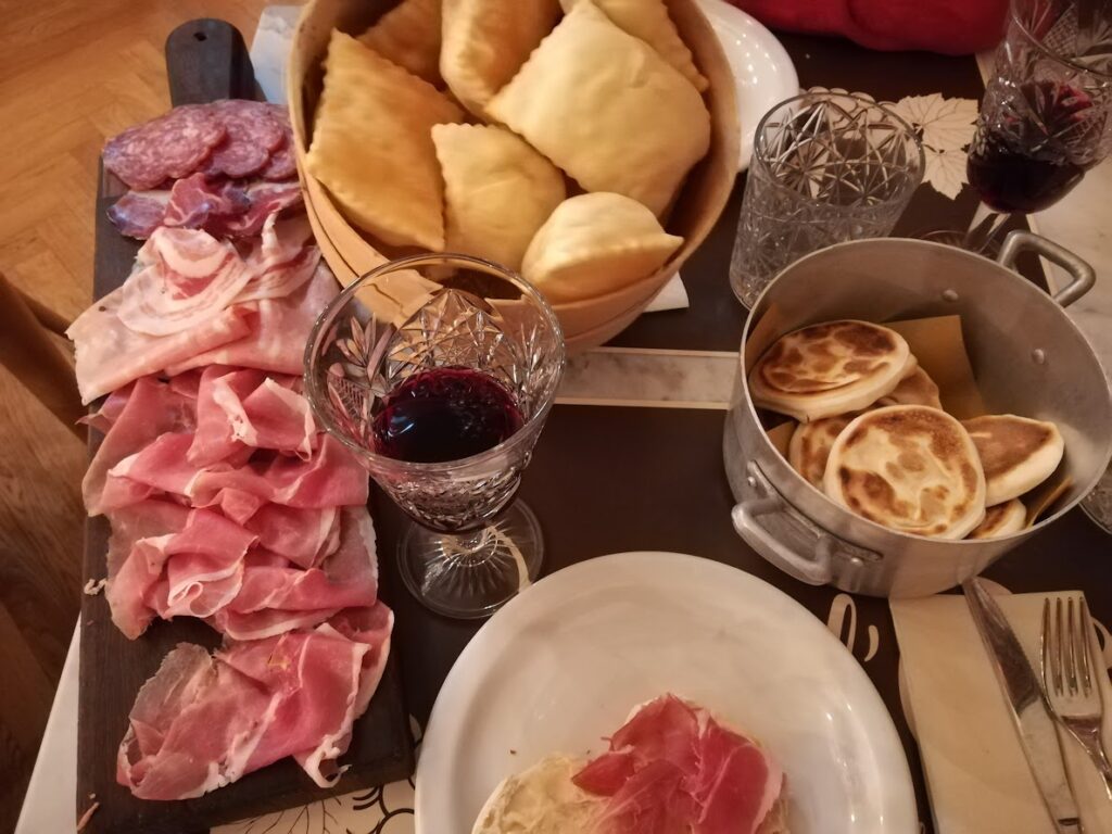 Assorted meats, cheeses, and pastries served with red wine, perfect for a delightful culinary experience.