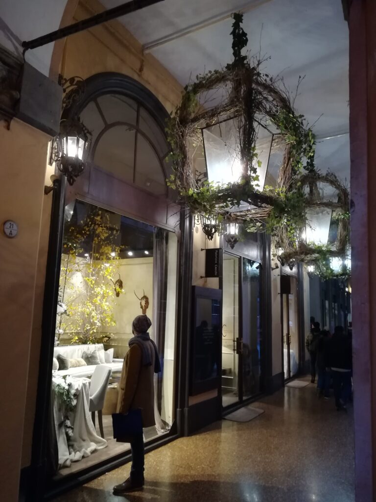 Bologna portico with Christmas decorations and shop windows