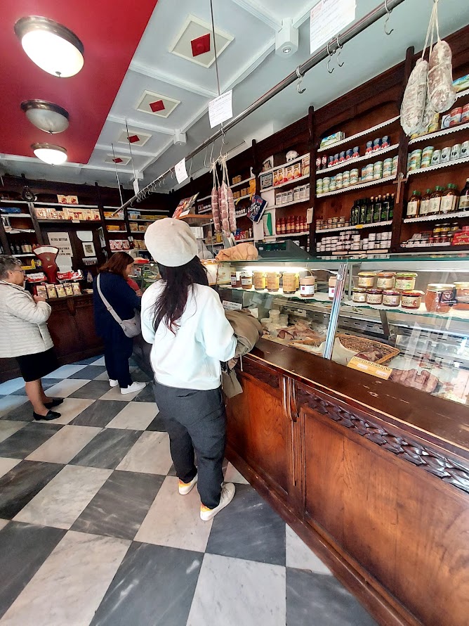 Outdoor Italian market with seasonal fruit, vegetables and artisan stalls
