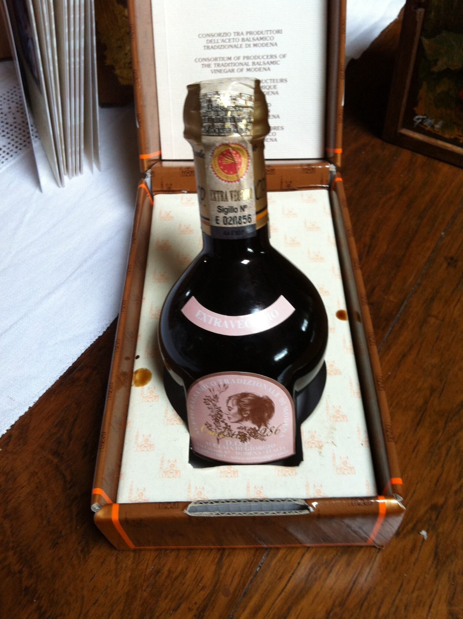 Traditional Balsamic Vinegar of Modena DOP in the official Giugiaro bottle presented at a restaurant table